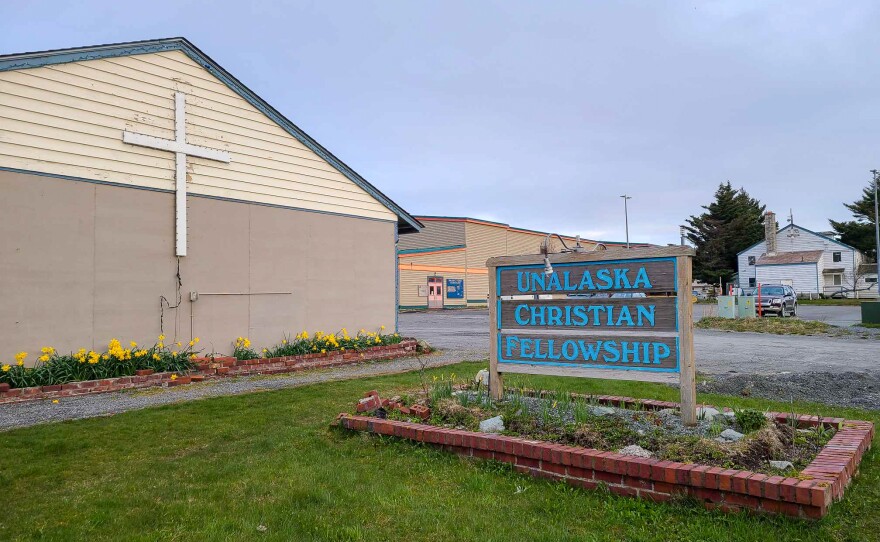 Unalaska Christian Fellowship building, cross, flowers, and church sign on East Broadway